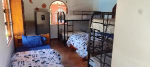 a room with two bunk beds and a window at las cabinas del sueño in Nicoya
