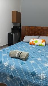 a bed with a pillow and a blanket on it at Lar Doce Lar Realizando Sono suíte1 in Arcos
