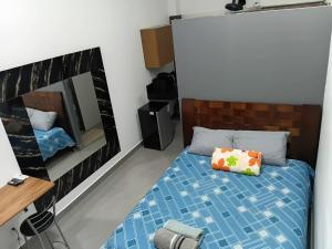 a small bedroom with a bed and a mirror at Lar Doce Lar Realizando Sono suíte1 in Arcos