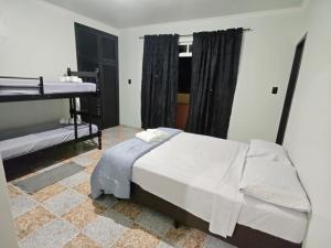 a bedroom with a large bed and a window at Casa temporada in Joinville