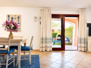 a dining room with a table and chairs and a door at GioYa House in Pittulongu