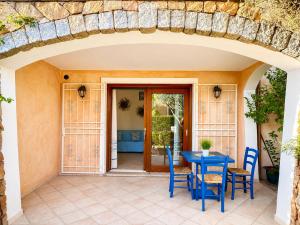 a patio with a blue table and chairs at GioYa House in Pittulongu +16 photos