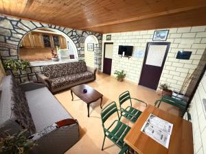 a living room with a couch and a table and chairs at Villa Adi in Ducaj