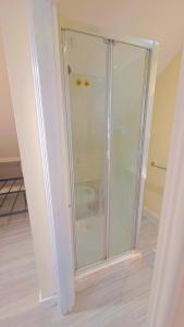 a glass shower stall in a room at studio with ensuite in New Bedfont +23 photos