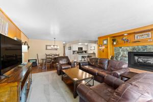 a living room with leather furniture and a fireplace at Lodgepole #2003 in Keystone +33 photos