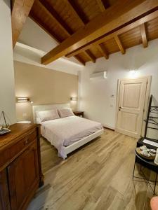 a bedroom with a bed and a wooden floor at Casa Iris in Omegna
