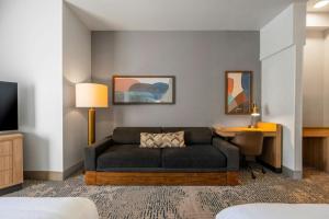 a living room with a couch and a desk at SpringHill Suites by Marriott Atlanta Kennesaw in Kennesaw