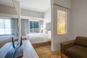 a hotel room with a bed and a couch at SpringHill Suites by Marriott Atlanta Kennesaw in Kennesaw +37 photos