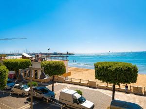 a parking lot next to a beach with cars parked at Malù camera doppia in Appartamento - lungomare Crotone in Crotone