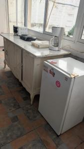 a kitchen with a counter top and a refrigerator at WinMen in El Sunzal