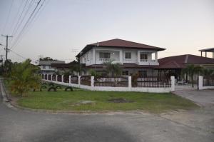 una cerca blanca frente a una casa en Riando appartement en Paramaribo