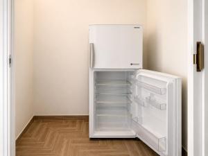 an empty refrigerator with its door open in a room at Malù camera doppia in Appartamento - lungomare Crotone in Crotone