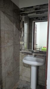 a bathroom with a sink and a mirror at WinMen in El Sunzal +3 photos