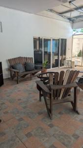two wooden chairs and a table in a room at WinMen in El Sunzal