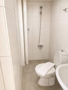 a white bathroom with a toilet and a sink at Giray Butik Hotel in Alanya