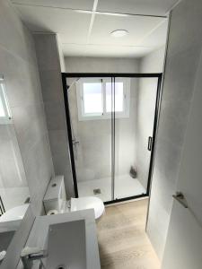 a bathroom with a toilet and a glass shower at Frida&Love in Torremolinos +10 photos