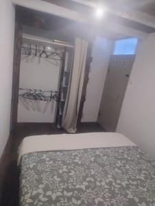 a bedroom with a bed in a room with a door at Chez Eli in Luri