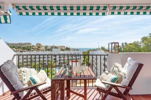 a patio with a table and two chairs on a balcony at APARTAMENT MIJAS BEACH, ÁNGEL in La Cala de Mijas