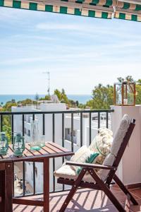 a patio table and chair on a balcony at APARTAMENT MIJAS BEACH, ÁNGEL in La Cala de Mijas