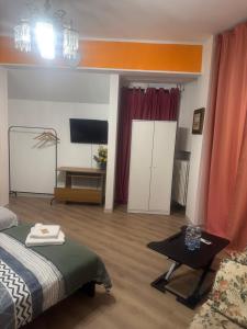 a bedroom with a bed and a table and a tv at Firenze inn 21 Florence in Florence
