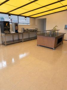 a large empty room with a cafeteria with a counter at Giray Hotel in Alanya
