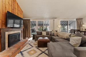 a living room with a couch and a fireplace at Snowbridge Square #F206 in Copper Mountain