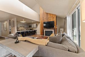 a living room with a couch and a fireplace at Snowbridge Square #F206 in Copper Mountain
