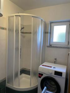 a shower in a bathroom with a washing machine at Apartments Marija in Cres +67 photos