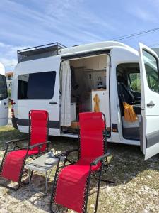 a white van with two chairs and a white van at Sprinter Camper Albania Rental in Tirana