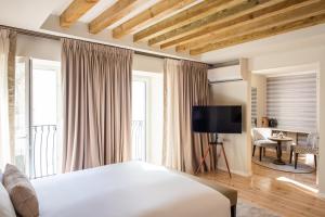 a hotel room with a bed and a television at Villa Dorothea in Lisbon