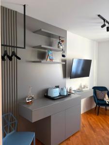 a room with a desk with a tv and a chair at Room with jungle bathroom in Dubrovnik +17 photos