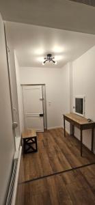 an empty room with a table and a ceiling fan at Chez Mary in Larzicourt +17 photos
