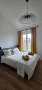 a bedroom with a large bed with two towels on it at Chez Mary in Larzicourt