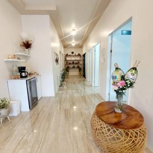 a hallway with a table with a vase of flowers at River Suite at Luna Negra Suites & Spa in El Castillo de La Fortuna
