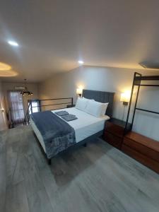 a bedroom with a bed with white sheets and pillows at River Suite at Luna Negra Suites & Spa in El Castillo de La Fortuna