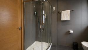 a shower with a glass door in a bathroom at The Apex Penthouse, Hyde Park in London +16 photos
