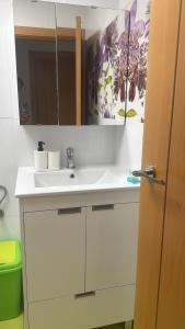 a bathroom with a white sink and a mirror at Veleta Montserrat - Alicante in Alicante +13 photos