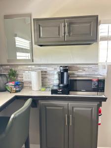 a kitchen with a counter top with a microwave at Couples Retreat in Nazareth +13 photos