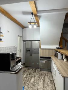 a kitchen with a stainless steel refrigerator at Casa Denis & Kevin in Petrila