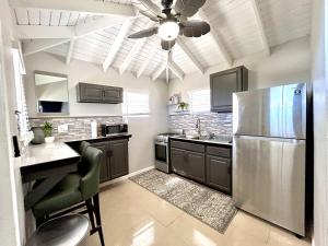 a kitchen with a stainless steel refrigerator and a ceiling fan at Couples Retreat in Nazareth