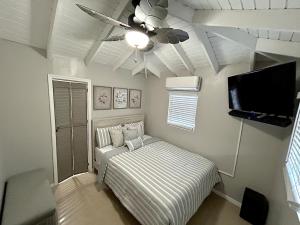 a bedroom with a bed and a ceiling fan at Couples Retreat in Nazareth