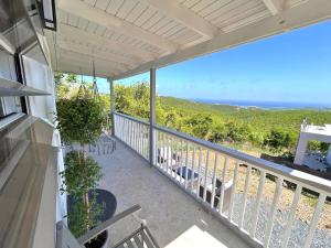 a balcony with chairs and a view of the ocean at Couples Retreat in Nazareth