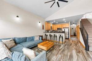 a living room with a blue couch and a kitchen at La Riva Del Lago #204 in Dillon