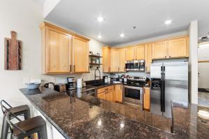 a kitchen with wooden cabinets and stainless steel appliances at La Riva Del Lago #204 in Dillon