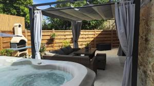 a jacuzzi tub in a yard with a patio at Dalmatian Stone House Angela in Drniš