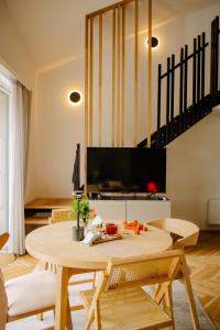 a living room with a table and a tv at Nomad Cabin Roztocze in Tereszpol Zaorenda
