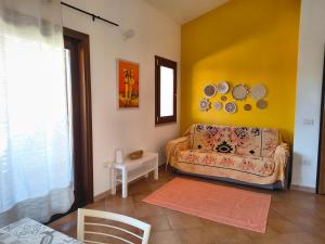a living room with a couch and a yellow wall at Seaside Home - Palau in Palau +19 photos