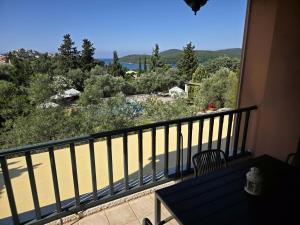 a balcony with a table and a view of the ocean at Alkyon Villas in Syvota