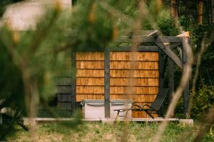 a wooden pergola with a toilet in the yard at Nomad Cabin Roztocze in Tereszpol Zaorenda +14 photos