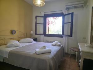 a bedroom with two beds with towels on them at Alkyon Villas in Syvota +53 photos